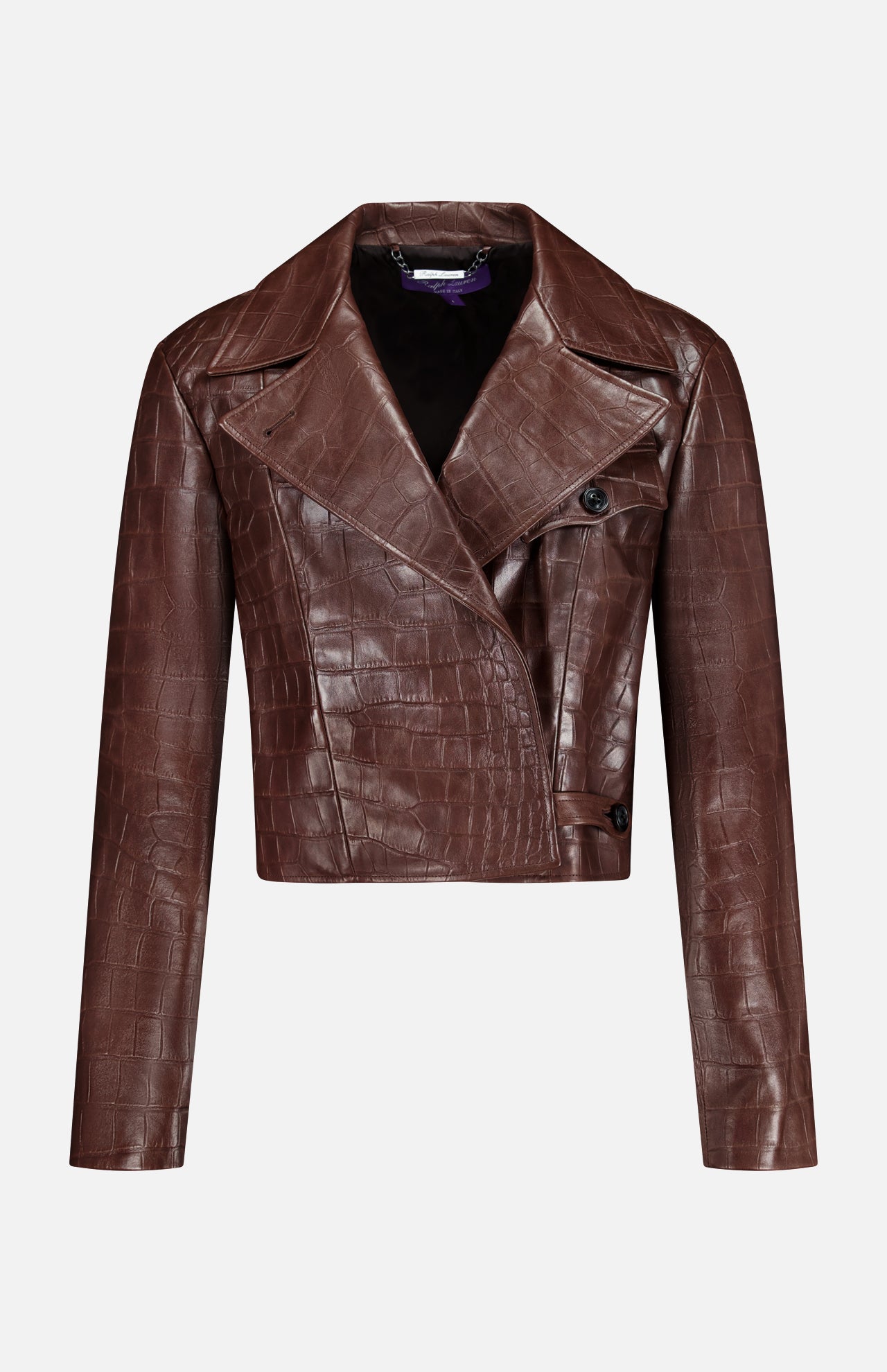 The Jaxson Leather Moto Jacket from the RALPH LAUREN COLLECTION is a cropped brown lambskin design with an eye-catching crocodile-embossed pattern, long sleeves, wide lapels, and an asymmetrical button closure—exuding the timeless sophistication of Ralph Lauren. Shown against a plain white background.