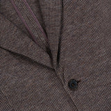 Close-up of the RALPH LAUREN COLLECTION Jersey Knit Blazer, Italian-made in brown tweed with a subtle check pattern, featuring two black buttons and a glimpse of the purple inner lining.