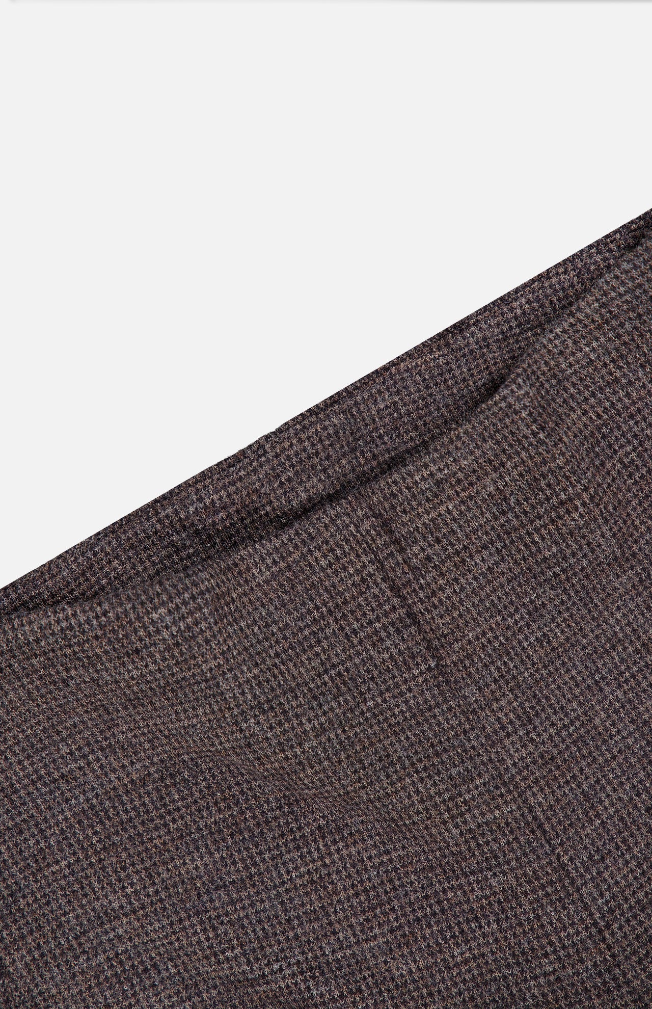A close-up view of the brown textured fabric from the RALPH LAUREN COLLECTION Jersey Knit Standard Straight Pants, displayed diagonally against a white background.