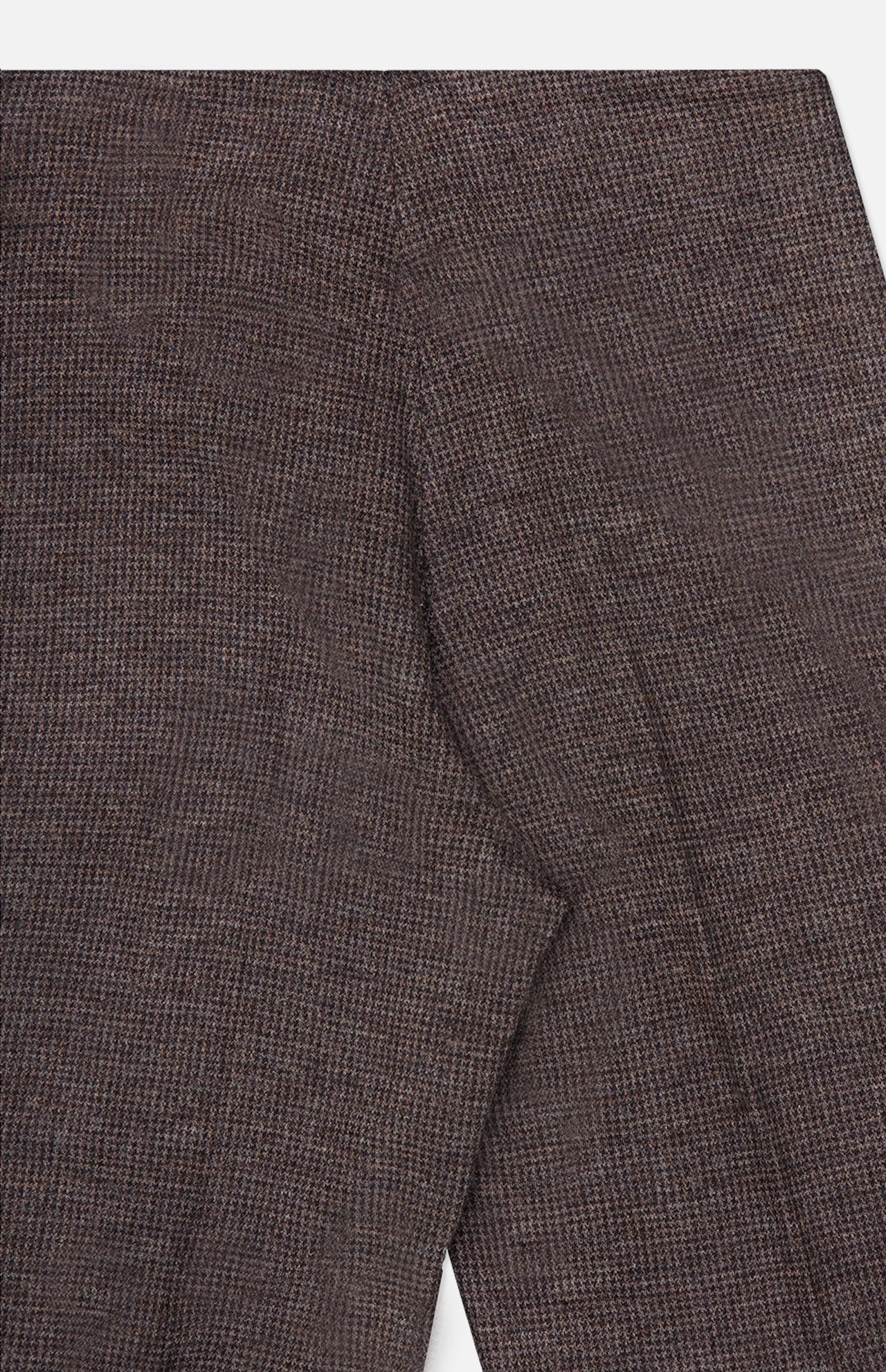 Close-up of brown textured fabric with visible stitching, likely part of a sleeve and shoulder seam on a garment—set against a white background—an ideal pairing with the Jersey Knit Standard Straight Pants from RALPH LAUREN COLLECTION for a refined ensemble.