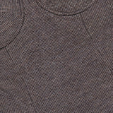 Close-up of a brown and gray textured wool jersey fabric from the RALPH LAUREN COLLECTION Jersey Knit Sweetheart Tank Top, featuring a circular seam detail. The subtle checked weave evokes structured elegance reminiscent of corset-inspired tailoring.