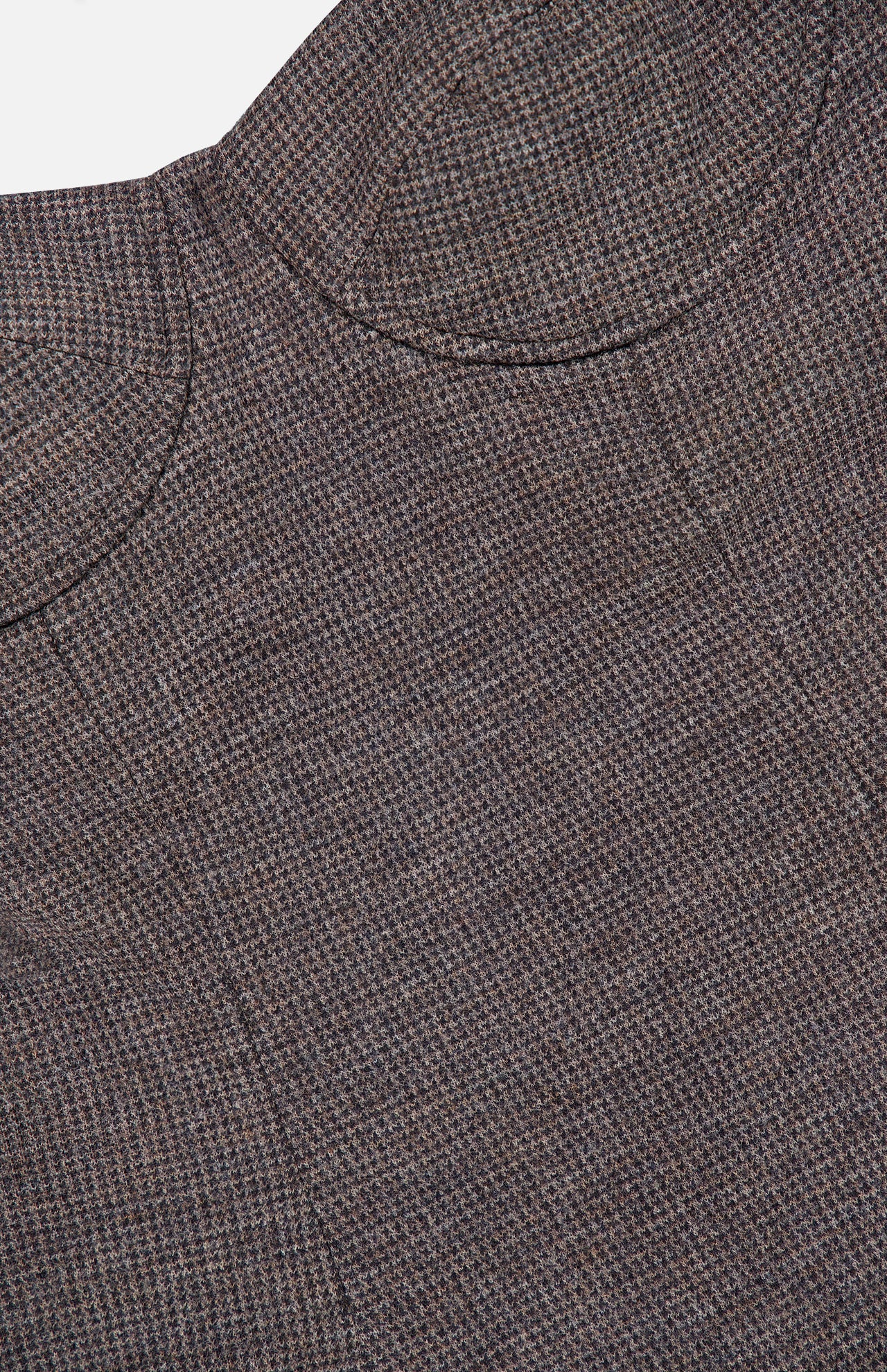 Close-up of a brown and gray textured wool jersey fabric from the RALPH LAUREN COLLECTION Jersey Knit Sweetheart Tank Top, featuring a circular seam detail. The subtle checked weave evokes structured elegance reminiscent of corset-inspired tailoring.