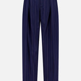 The Jody Pleated Trouser Pant by RALPH LAUREN COLLECTION features dark blue ultrafine wool crepe with vertical white pinstripes, front pleats, belt loops, and a straight-leg silhouette, shown against a plain white background.
