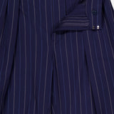 The Jody Pleated Trouser Pant by RALPH LAUREN COLLECTION features navy pinstripes in ultrafine wool crepe, with pleats and a straight-leg silhouette, shown partially unzipped to display the inner waistband and closure details.