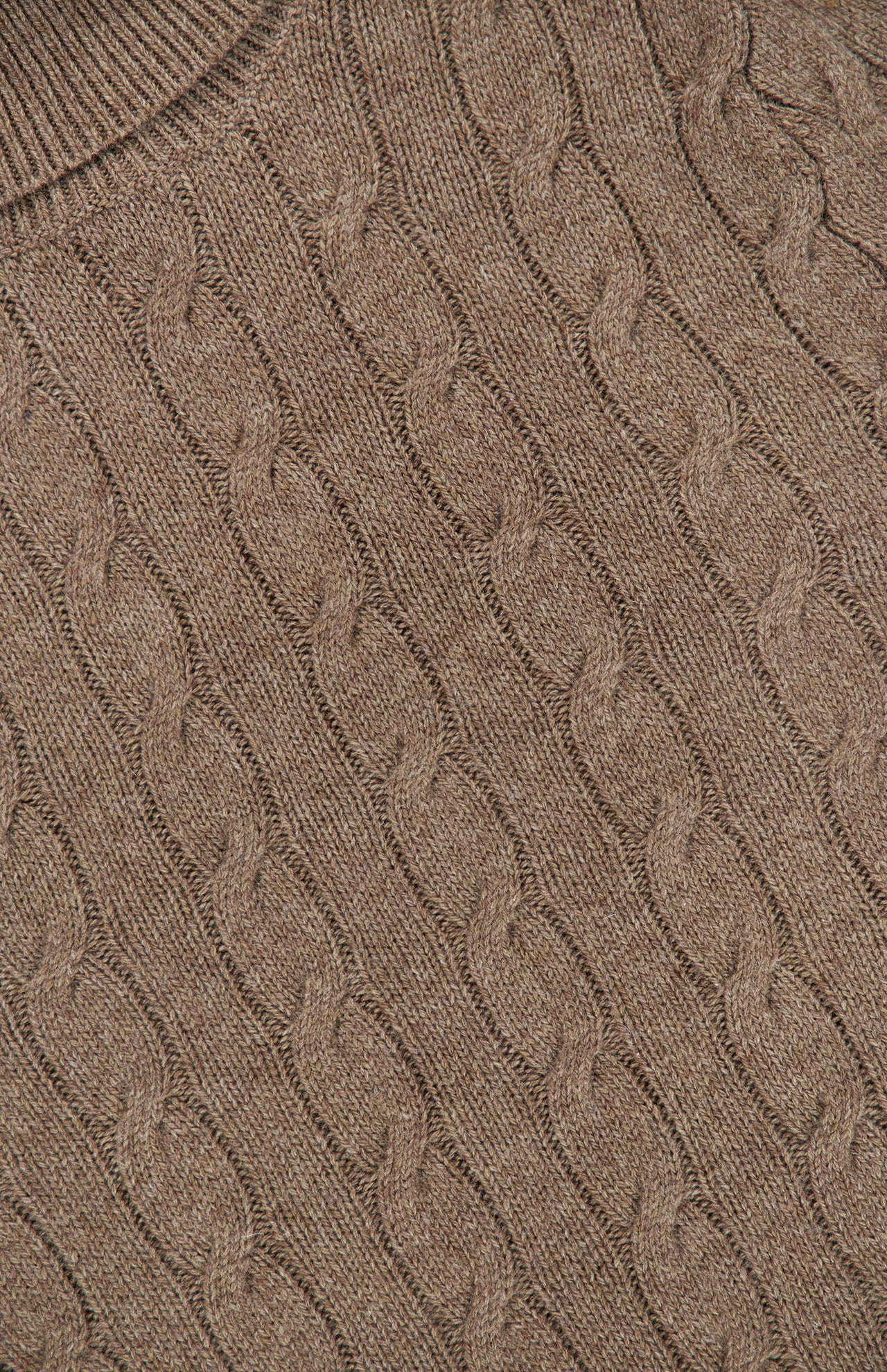 Close-up of the Lofty Cashmere Turtleneck Sweater by RALPH LAUREN COLLECTION, showcasing the textured, twisted knit pattern characteristic of classic cable-knit designs. The image highlights the intricate detail and sumptuous, cozy feel of Italian cashmere.