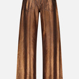 The Mercer Cotton Denim Full Length Wide Pant by RALPH LAUREN COLLECTION features a metallic bronze wide-leg design, two back pockets, a leather waistband patch, and a shiny, reflective finish.