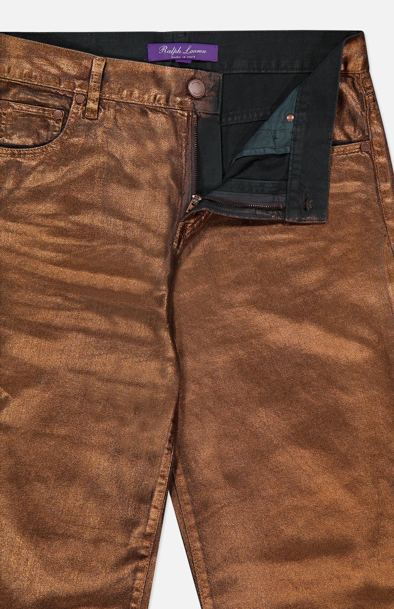 Close-up of the Mercer Cotton Denim Full Length Wide Pant by RALPH LAUREN COLLECTION, shown in metallic bronze with a shiny, textured finish, partially unzipped fly, black interior lining, waistband label, and visible front pocket stitching.