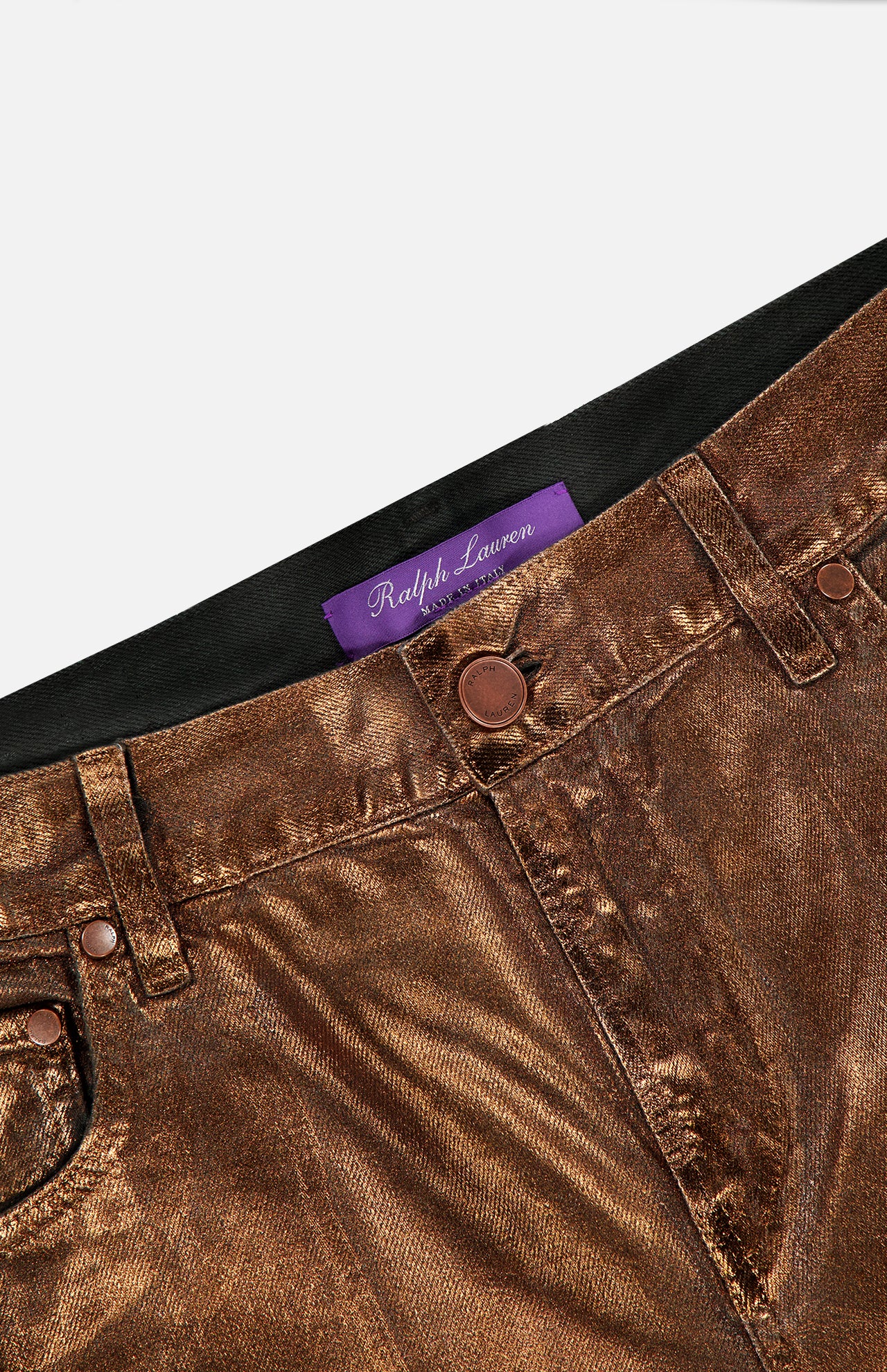 Close-up of Mercer Cotton Denim Full Length Wide Pant by RALPH LAUREN COLLECTION, featuring metallic bronze finish, button closure, belt loops, and a purple label inside the waistband, highlighting the brand’s signature wide-leg denim style.
