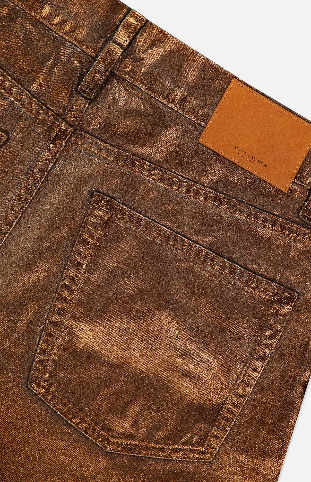 Close-up of the back of Mercer Cotton Denim Full Length Wide Pant from RALPH LAUREN COLLECTION, showcasing a wide-leg silhouette, large back pocket, belt loop, and tan leather patch with embossed branding near the waistband.
