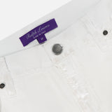 Close-up of the waistband on Mercer Wide Leg Jeans by RALPH LAUREN COLLECTION, in white eco stone-washed denim, featuring a silver button, belt loops, and a purple Ralph Lauren label stitched inside.