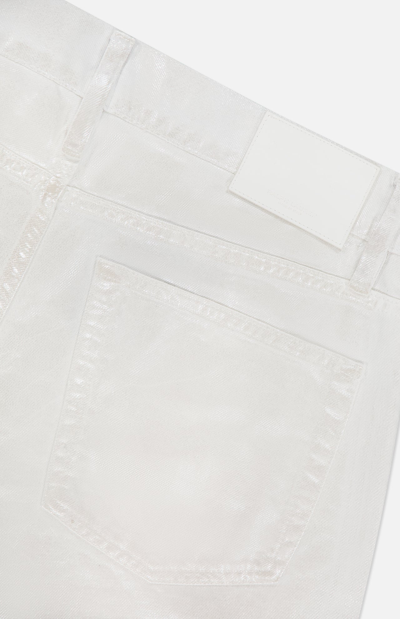 Close-up of the back pocket and waistband of Mercer Wide Leg Jeans by RALPH LAUREN COLLECTION, featuring eco stone-washed white denim with stitching details, belt loops, and a blank white label.