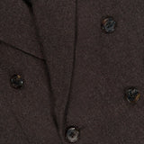 Close-up of the RALPH LAUREN COLLECTION Mini Herringbone Blazer, highlighting its dark brown wool construction, six black and brown marbled buttons, and textured herringbone fabric.
