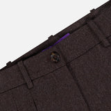 Close-up of the waistband and upper section of the Mini Herringbone Standard Pants by RALPH LAUREN COLLECTION in dark brown suiting wool flannel, featuring a button closure, belt loops, and visible seam details on a plain background.