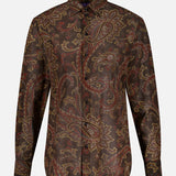 Elevate your fall wardrobe with the Paisley Collared Long Sleeve Blouse from RALPH LAUREN COLLECTION—a button-up blouse featuring long sleeves and a dark brown base adorned with an intricate paisley print in rich shades of red, gold, and tan.