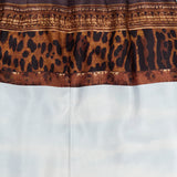 A close-up of the RALPH LAUREN COLLECTION Scenic Silk Twill Pencil Skirt, showcasing its brown waistband, leopard print strip, light blue lower section, and back zipper detail. Expertly crafted in Italy, this chic skirt exemplifies refined style.