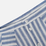 Close-up of the RALPH LAUREN COLLECTION Shamus Linen Umbrella Stripe Maxi Skirt in blue and white stripes, featuring a waistband with belt loops and three white buttons—crafted from lightweight linen for coastal style.