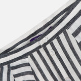 Close-up of a black and white vertically striped shirt, with its button placket and collar, paired perfectly with the RALPH LAUREN COLLECTION Shamus Umbrella Stripe Maxi Skirt for a chic, coordinated look.