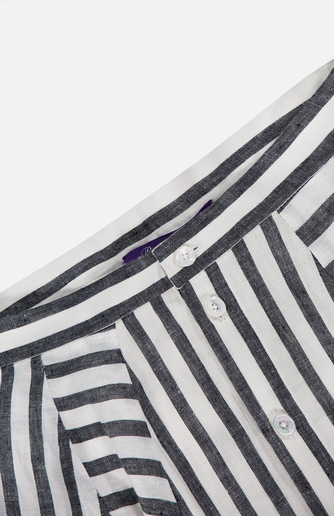 Close-up of a black and white vertically striped shirt, with its button placket and collar, paired perfectly with the RALPH LAUREN COLLECTION Shamus Umbrella Stripe Maxi Skirt for a chic, coordinated look.
