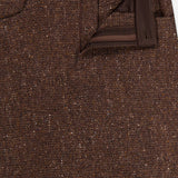 Close-up of the Tweed Ankle Pencil Skirt by RALPH LAUREN COLLECTION featuring a visible waistband, belt loop, button, zipper fly, and dark brown trim along the inside of the waistband and fly.
