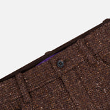 Close-up of the Tweed Ankle Pencil Skirt by RALPH LAUREN COLLECTION, featuring brown tweed fabric, a visible black button, belt loops, and a front pocket, set against a plain white background.