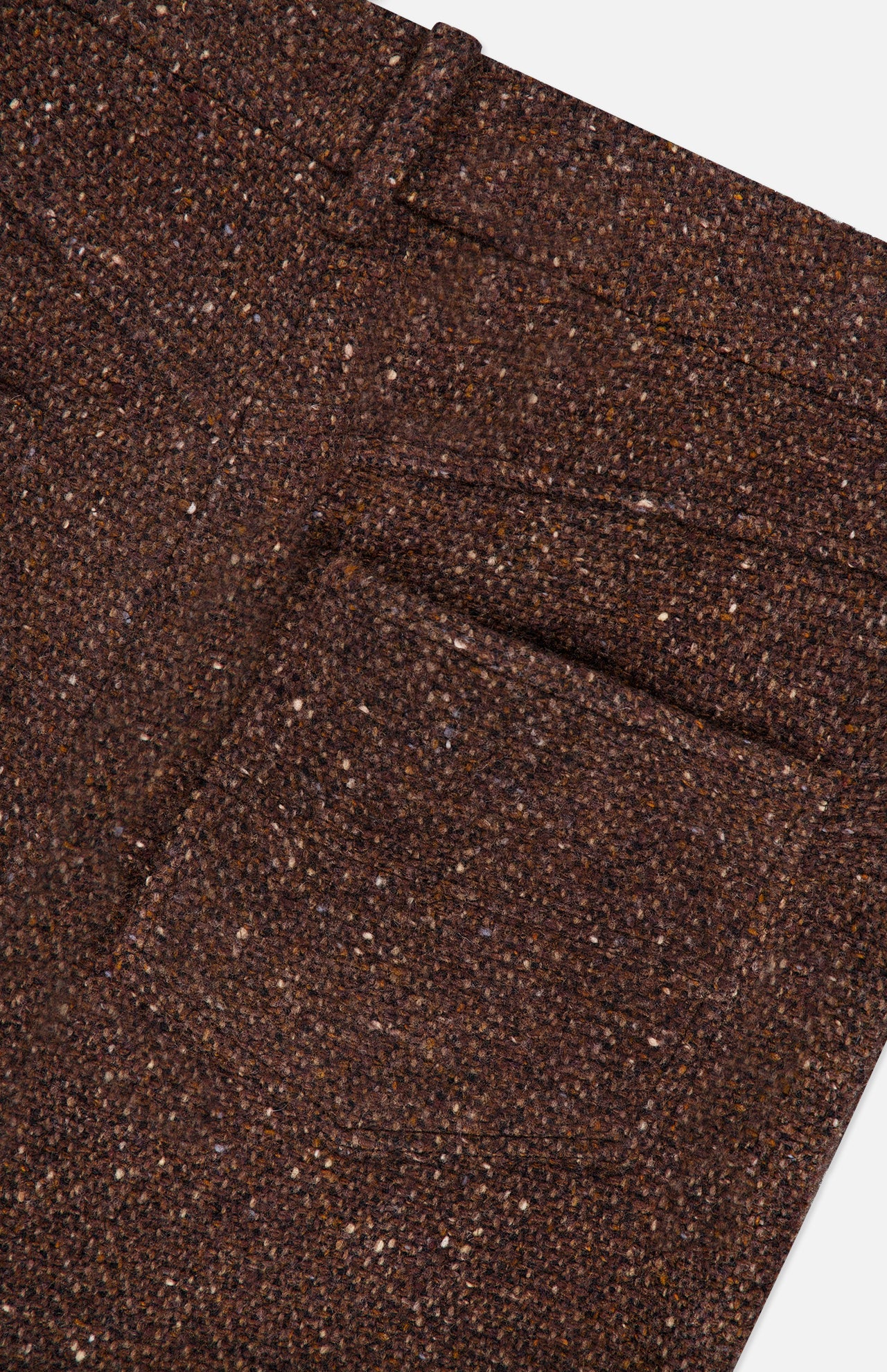 Close-up of the Tweed Ankle Pencil Skirt by RALPH LAUREN COLLECTION, highlighting the brown tweed fabric’s textured weave, visible stitching, and subtle color variations—evoking the timeless elegance of classic tailored skirts.