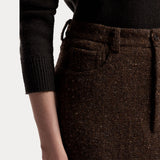 A person wearing a black long-sleeve top and the RALPH LAUREN COLLECTION Tweed Ankle Pencil Skirt. Only the torso and left arm are visible against a plain light background.