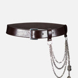 The Washed Calfskin Belt by RALPH LAUREN COLLECTION is a dark brown full-grain leather belt with a silver buckle, detailed with three silver chains and two pendants on one side.