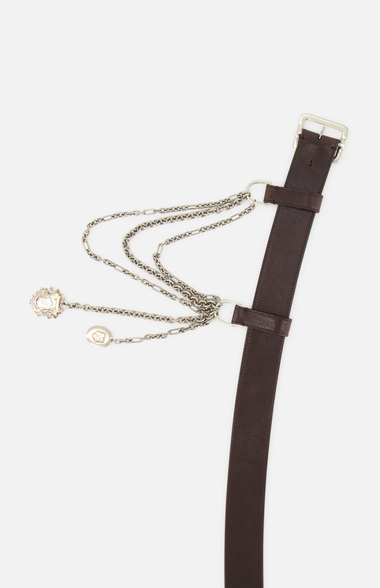 The Washed Calfskin Belt by RALPH LAUREN COLLECTION features brown full-grain leather, a silver buckle, bold chain detail, and two charms—perfect for making a statement with any outfit.
