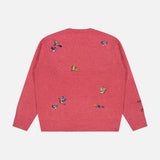 The Ducks Fly Crewneck Sweater by RALPH LAUREN POLO is a pink wool alpaca blend featuring small, colorful embroidered ducks scattered across the back and left sleeve. With its slightly loose fit and ribbed cuffs and hem, this cozy sweater offers a rustic twist on the classic crew neck design.