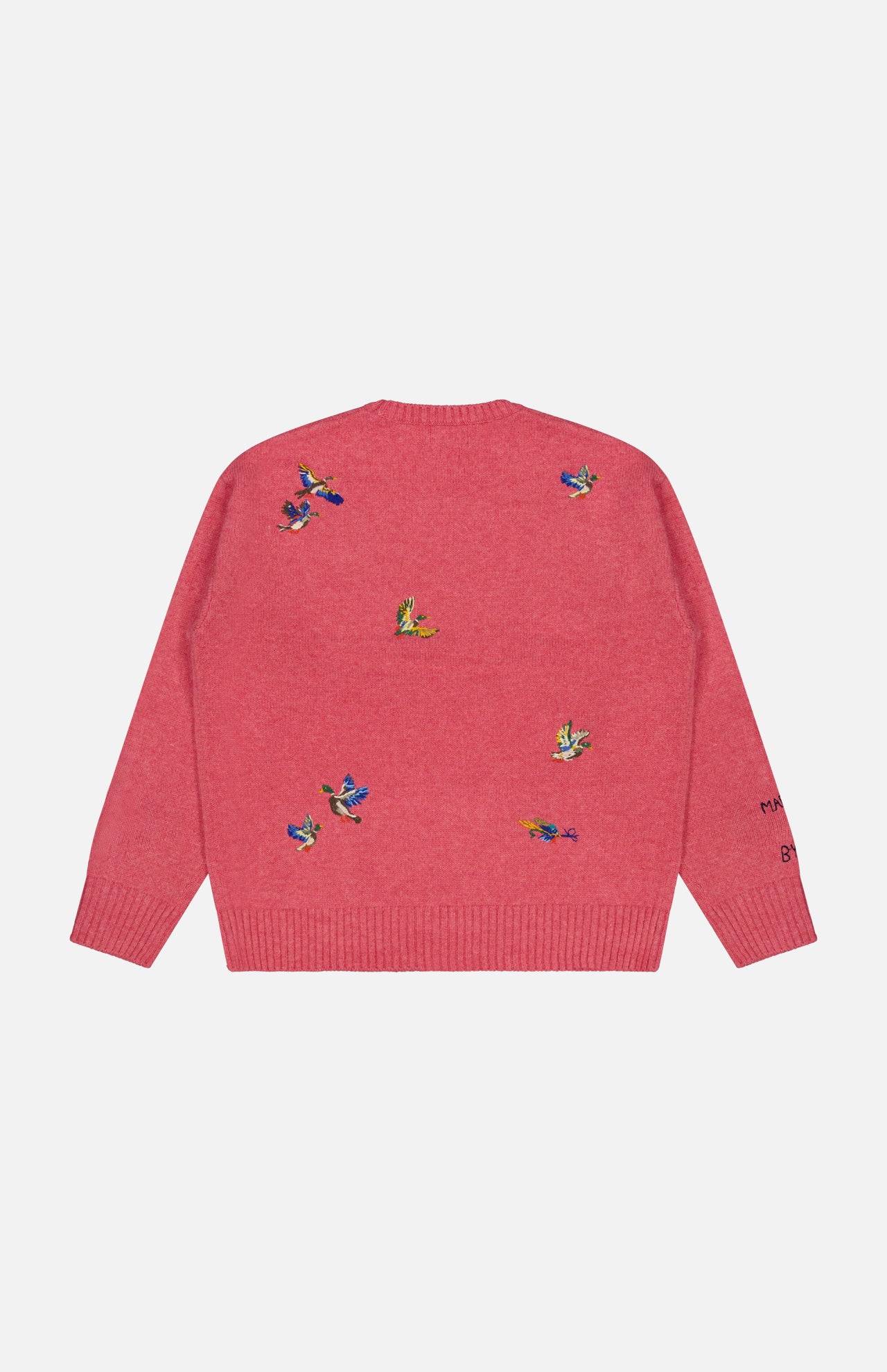 The Ducks Fly Crewneck Sweater by RALPH LAUREN POLO is a pink wool alpaca blend featuring small, colorful embroidered ducks scattered across the back and left sleeve. With its slightly loose fit and ribbed cuffs and hem, this cozy sweater offers a rustic twist on the classic crew neck design.