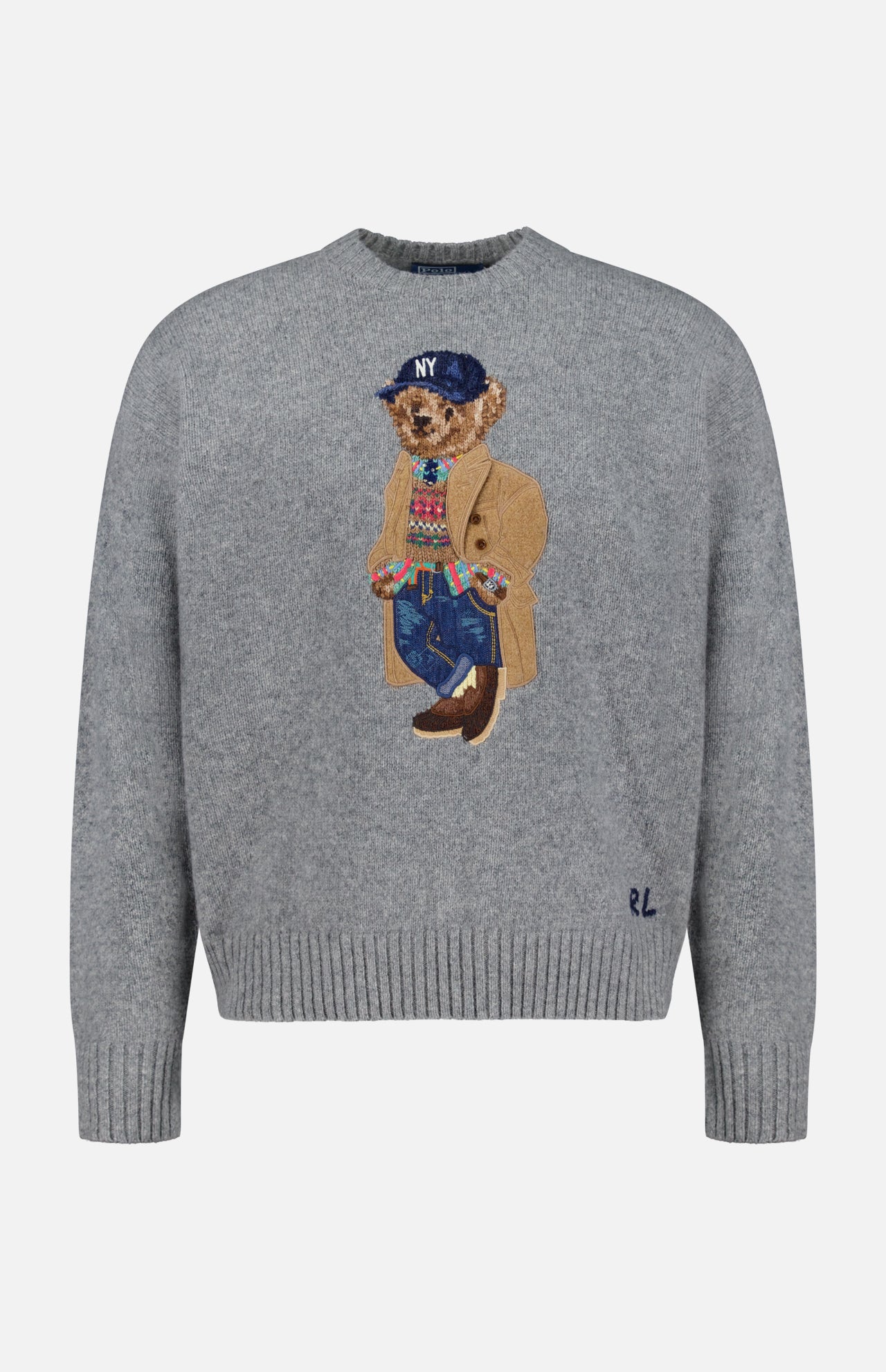 The Novelty Heritage Bear Crewneck Sweater by RALPH LAUREN POLO features a gray knit design with an embroidered bear dressed in a tan coat, blue jeans, colorful sweater, brown shoes, and a navy NY cap. Signature RL initials are stitched near the right side of the bottom hem, offering a classic finish inspired by timeless wool-cashmere sweaters.