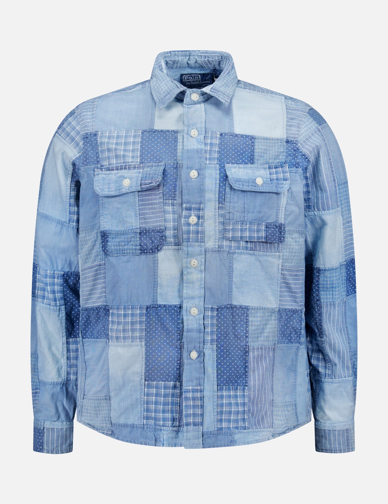 The Patchwork Chicago Long Sleeve Workshirt by RALPH LAUREN POLO is made from indigo-dyed patchwork denim with checks, stripes, and polka dots, featuring two chest flap pockets and white buttons.