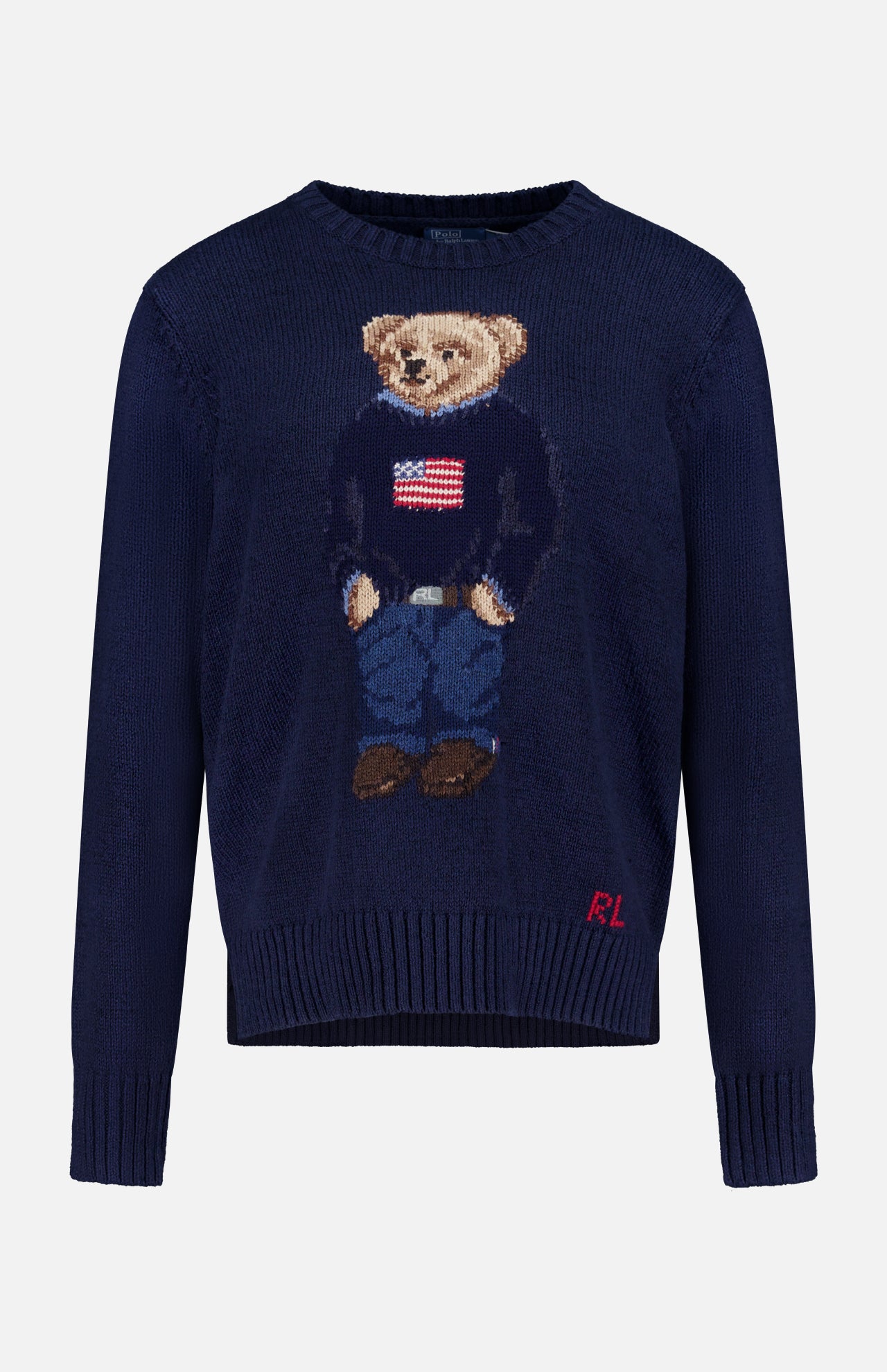 The Cotton Linen Long Sleeve Bear Pullover Sweater by RALPH LAUREN POLO features a bear in a flag sweater, blue jeans, and brown shoes, with "RL" initials on the lower front corner.