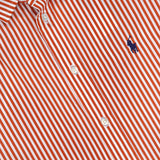 The Cotton Poplin Long Sleeve Blouse from RALPH LAUREN POLO is a relaxed-fit, red and white vertically striped cotton shirt with a collared button-down design featuring white buttons and a small dark blue embroidered Pony logo of a horse and rider on the chest.