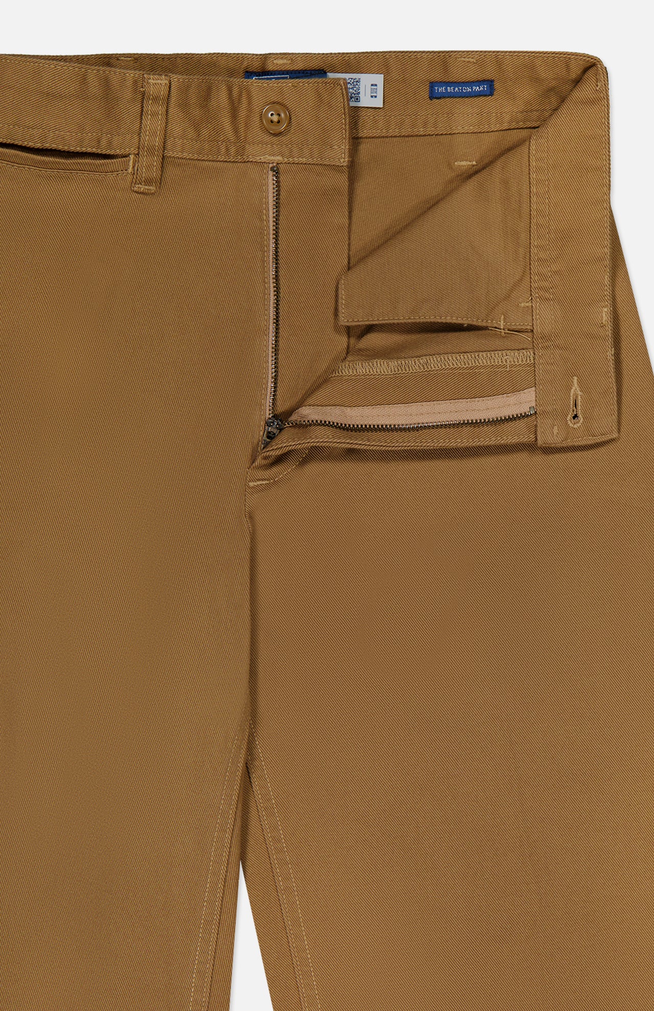 Close-up of brown Cotton Twill Flare Pants by RALPH LAUREN POLO, featuring a high-rise silhouette with the waistband, zipper, and button fly partially open to reveal the inside stitching and pocket lining. The pants are neatly pressed and laid flat.