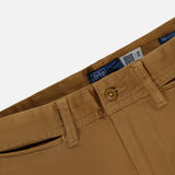 Close-up of tan Cotton Twill Flare Pants featuring belt loops, a button closure, zipper fly, and a visible RALPH LAUREN POLO brand label inside the waistband.