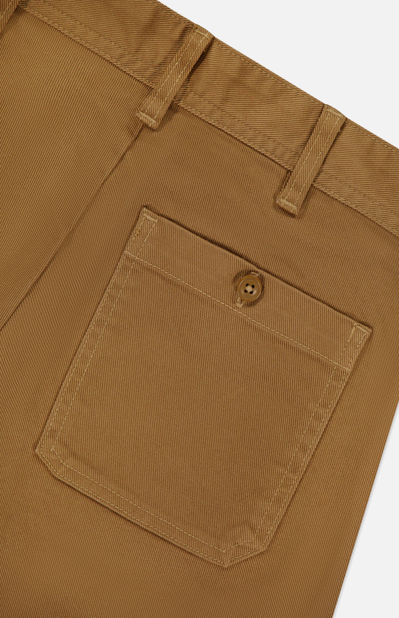 Close-up of a brown pair of Cotton Twill Flare Pants by RALPH LAUREN POLO, featuring a pocket with button closure, belt loops, and visible stitching detail.