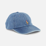 The RALPH LAUREN POLO Denim Sport Cap is crafted from light blue denim and features embroidered eyelets, along with the iconic Pony—a small polo player on horseback—stitched on the front. Designed for comfort, it includes an adjustable back strap and is displayed against a plain white background.