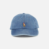 The RALPH LAUREN POLO Denim Sport Cap is a blue denim ball cap featuring a small, centered embroidered Pony logo of a person riding a horse above the brim. The cap includes an adjustable back strap and is displayed against a plain white background.