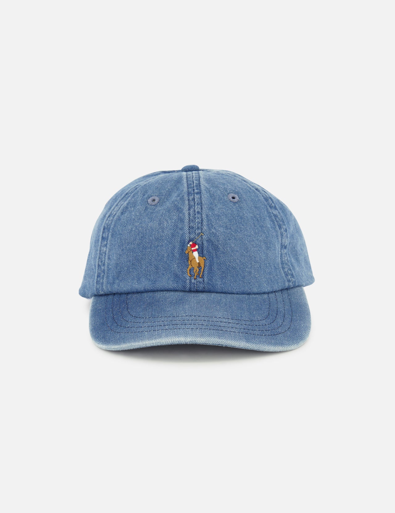 The RALPH LAUREN POLO Denim Sport Cap is a blue denim ball cap featuring a small, centered embroidered Pony logo of a person riding a horse above the brim. The cap includes an adjustable back strap and is displayed against a plain white background.