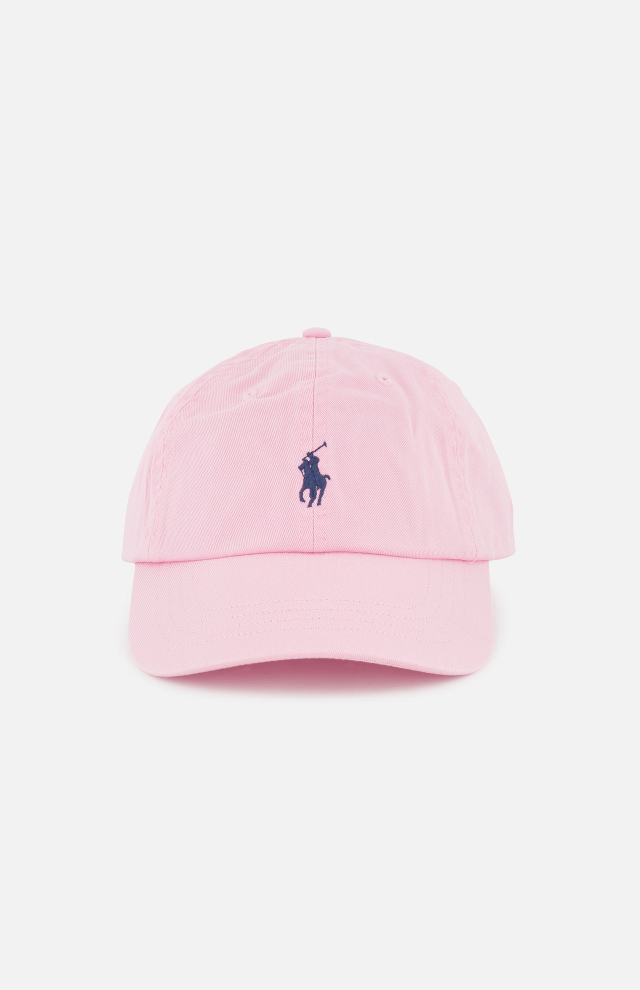 The Twill Logo Cap by RALPH LAUREN POLO is a light pink cotton chino ball cap with a curved brim, featuring a small navy embroidered Polo Pony logo on the front and shown against a plain white background.