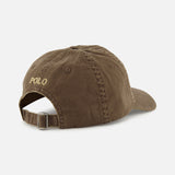 A back view of the RALPH LAUREN POLO Twill Sport Cap in brown cotton, showcasing a yellow embroidered Polo logo and an adjustable strap with a metal buckle.
