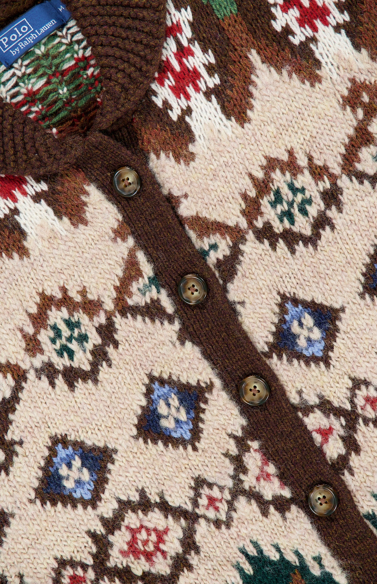 Ralph Lauren Polo Wool Shawl Collar Cardigan in cream wool and cashmere, featuring a brown shawl collar, a multi-colored geometric Fair Isle pattern, and brown front buttons.