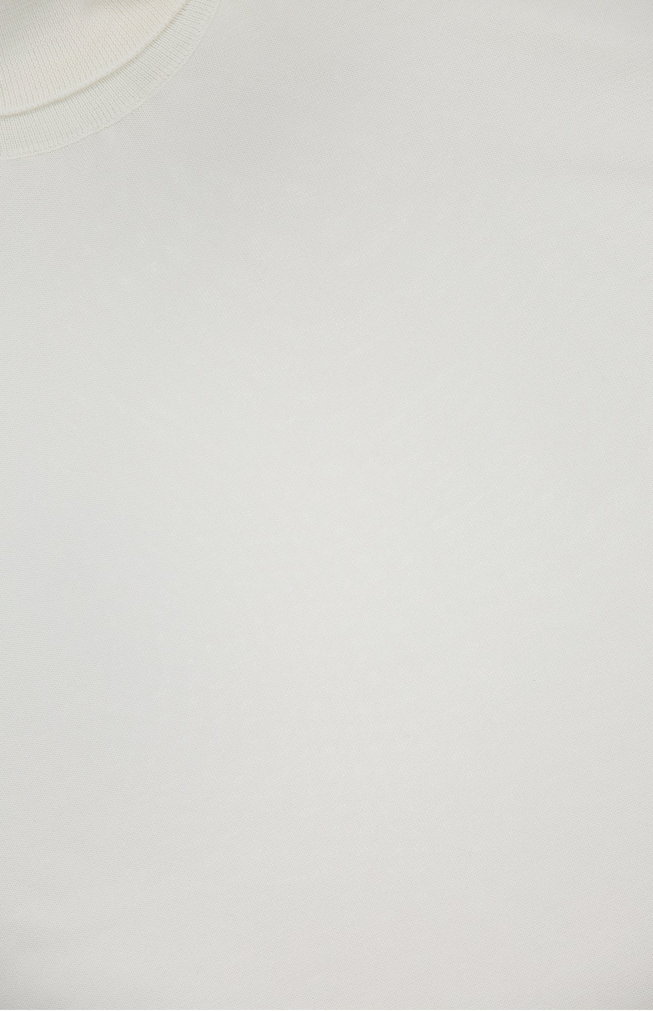 Close-up of a plain white RALPH LAUREN PURPLE LABEL Cotton Jersey Turtleneck Sweater, highlighting the texture and part of the neckline in the upper left corner. No logos, patterns, or other details are visible.