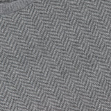 Close-up of a gray RALPH LAUREN PURPLE LABEL Herringbone Textured Crewneck Sweater, featuring a luxurious Italian-made herringbone knit and the signature purple label sewn into the neckline.
