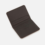 Introducing the Burnish Calf Wallet by RALPH LAUREN PURPLE LABEL—an open, dark brown luxury card case crafted from supple calfskin leather. Featuring two card slots on each side and displayed elegantly against a white background, this wallet is expertly made in Italy, embodying timeless craftsmanship and sophisticated style.