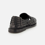 The Burnished Vacchetta Casual Loafer by RALPH LAUREN PURPLE LABEL is shown from the back at an angle, showcasing its intricate woven leather and closed heel against a plain white background.