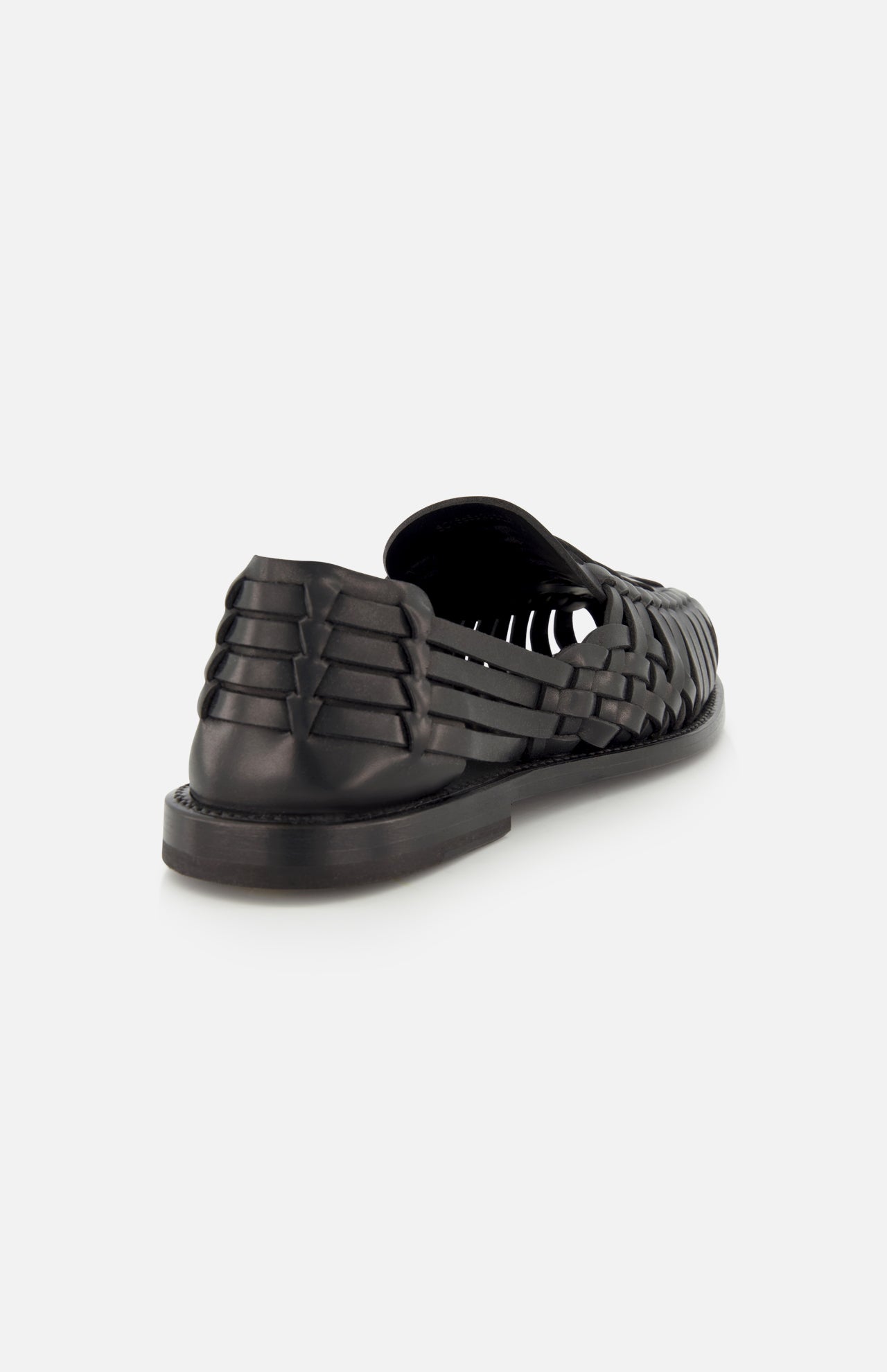 The Burnished Vacchetta Casual Loafer by RALPH LAUREN PURPLE LABEL is shown from the back at an angle, showcasing its intricate woven leather and closed heel against a plain white background.