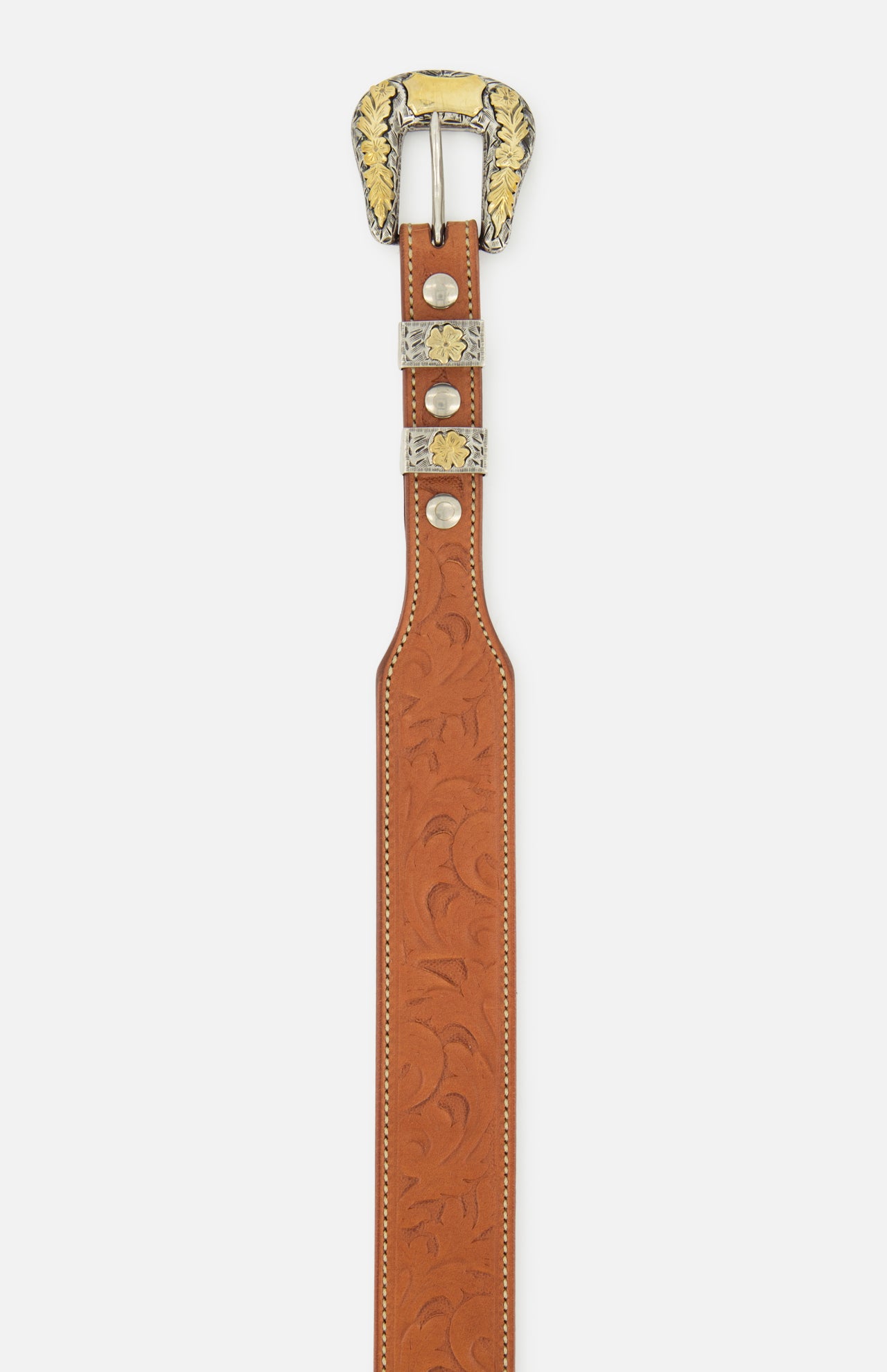 Ralph Lauren Purple Label Western Vacchetta Belt in tan floral-embossed leather featuring intricate metal hardware, an ornate silver and gold-tone buckle, and decorative metal accents.