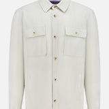 The Calloway Suede Knit Overshirt by RALPH LAUREN PURPLE LABEL is a light beige shirt jacket featuring a collar, two chest flap pockets with buttons, and two vertical side pockets. Displayed on a plain white background, this piece exemplifies exceptional Italian craftsmanship.